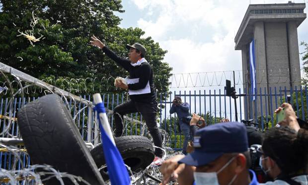 People protest in front of the Congress building in San Salvador against Bitcoins, other economic activities and the order dismissing judges