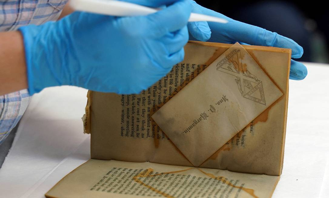 The professional holds a book found in a time capsule retrieved from the Confederate General Monument Robert E. Lee Image: REUTERS/Jay Paul