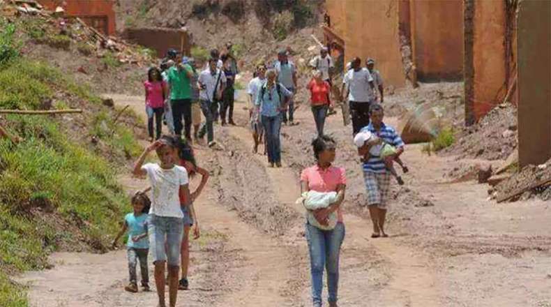 Affected, displaced people from Pento Rodriguez protested in streets covered with tails in the ruins of a village affected by the collapse of a Nithi dam.